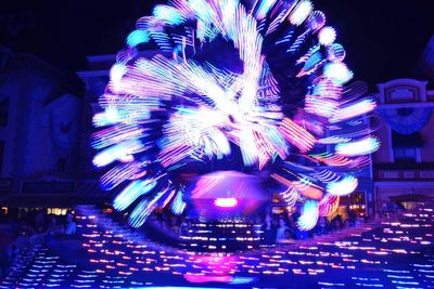 Low angle view of firework display at night