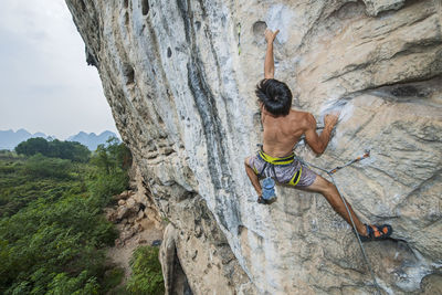 Man climbing on the limestone cliff "white mountain" in yangshuo