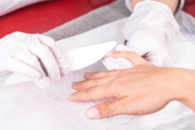 Close-up of woman lying on hand