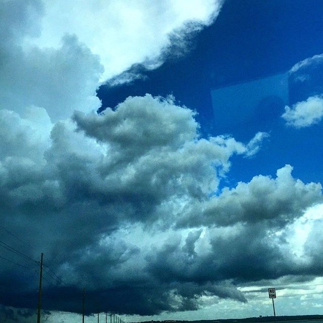 sky, cloud - sky, low angle view, cloudy, weather, cloud, cloudscape, nature, beauty in nature, overcast, tranquility, blue, scenics, storm cloud, electricity, silhouette, tranquil scene, power line, dramatic sky, fuel and power generation