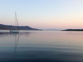 Sailboat sailing on sea against clear sky