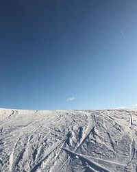 Scenic view of snowcapped mountains against clear blue sky