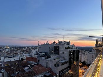 High angle view of buildings in city against sky during sunset