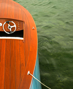 High angle view of orange boat moored in sea