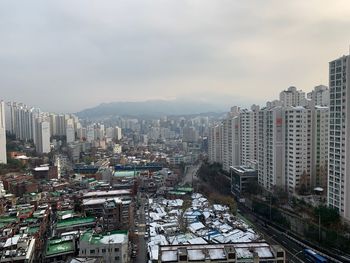 High angle view of city buildings against sky