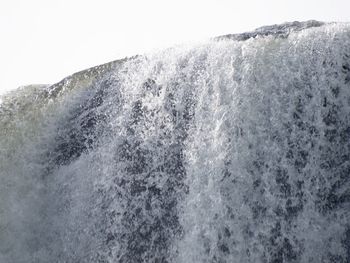 High angle view of waves in sea against clear sky