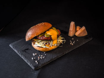 Close-up of burger on black background