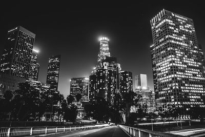 Illuminated cityscape against sky at night