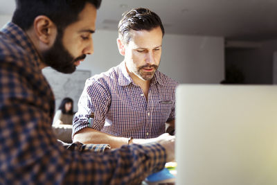 Businessmen working at desk in office