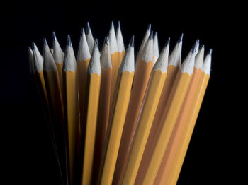 Close-up of colored pencils against black background