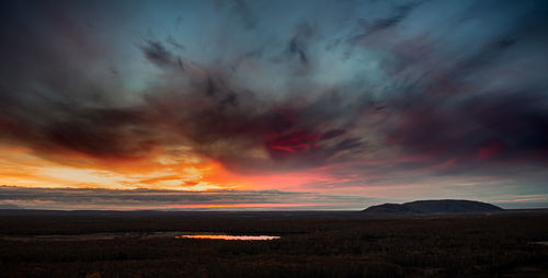 Scenic view of dramatic sky over land