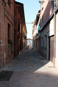 Empty alley amidst buildings in city