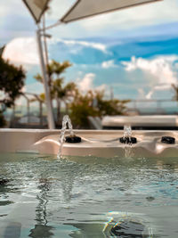 Close-up of swimming pool against sky