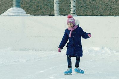 Full length of cute girl standing in ice