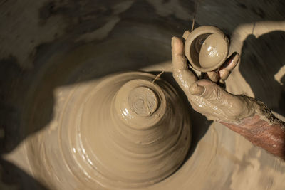 Cropped image of person making pottery