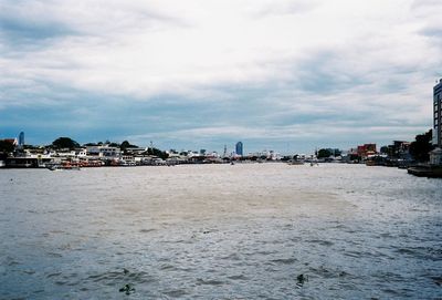 Scenic view of sea and buildings against sky