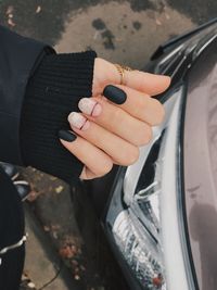 Close-up of woman hand holding car