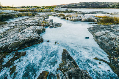 Scenic view of river against sky during winter