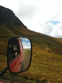 Side view of car on landscape against sky