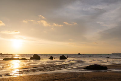 Scenic view of beach against sky during sunset