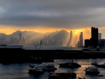 Panoramic view of sea and buildings against sky during sunset