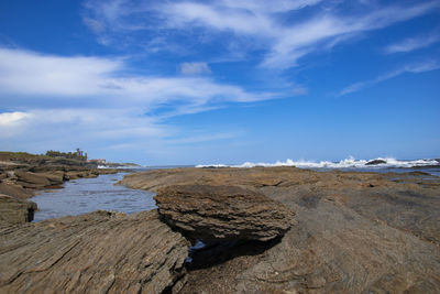 Scenic view of beach against blue sky