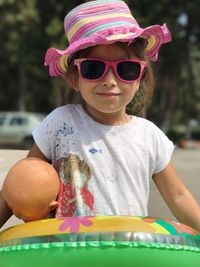 Close-up of cute girl wearing sunglasses and hat