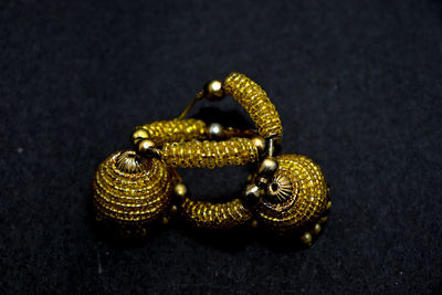 High angle view of gold colored pencils on table