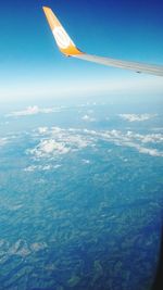 Cropped image of airplane flying over landscape