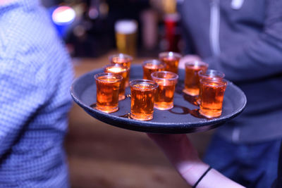 Close-up of hand holding candles on table