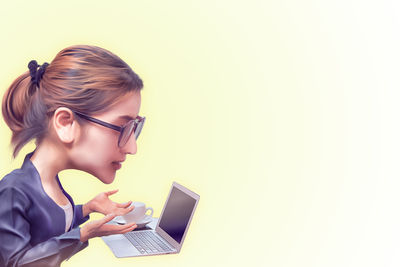 Side view of young woman using mobile phone