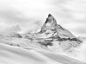 Scenic view of snow covered mountain against sky