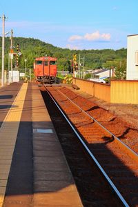 Train at railroad tracks against sky