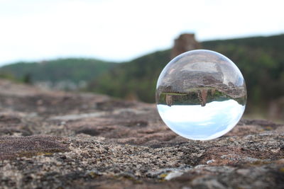 Close-up of crystal ball on glass