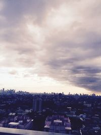 Buildings against cloudy sky