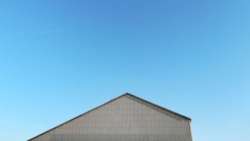 Low angle view of building against clear blue sky