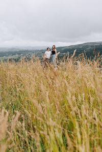 Couple on field against sky