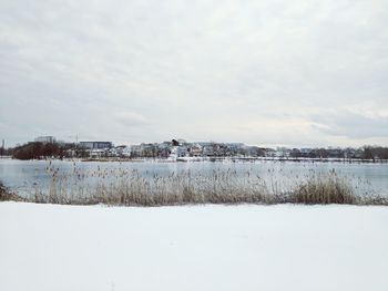 Scenic view of lake against sky during winter