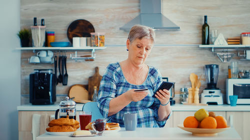 Portrait of young woman sitting at home