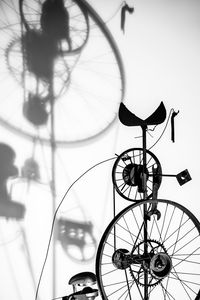 Low angle view of bicycle wheel against wall