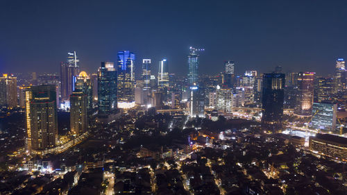 Aerial view of illuminated buildings in city at night