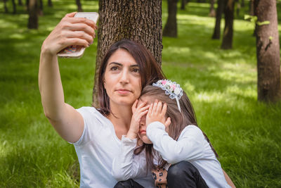 Portrait of young woman on field