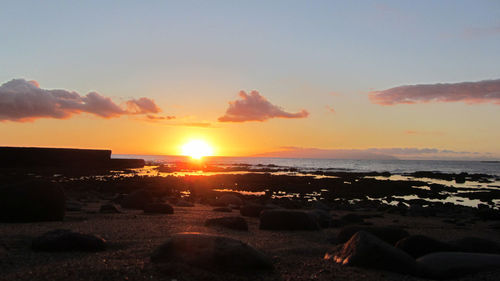 Scenic view of beach at sunset