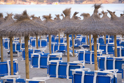 Chairs and tables on sand at beach