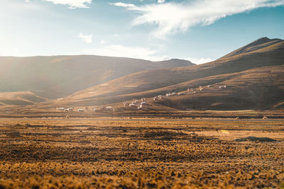 Scenic view of landscape and mountains against sky