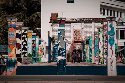 Graffiti on building by street in city