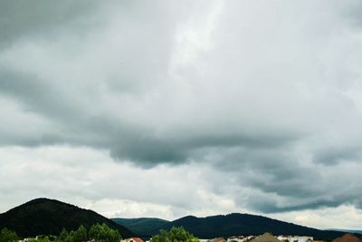 Scenic view of mountains against cloudy sky