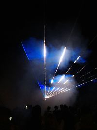 Low angle view of illuminated ferris wheel at night