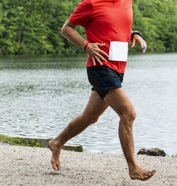 Full length of man standing by lake