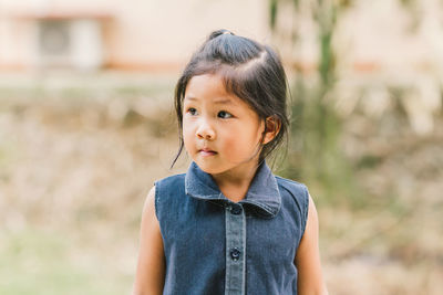 Portrait of cute girl standing outdoors